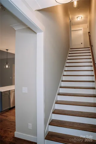 a view of entryway and hall with wooden floor