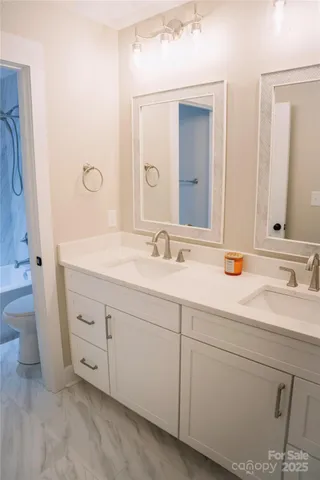 a bathroom with a double vanity sink and mirror
