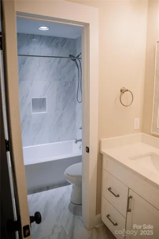 a bathroom with a shower and a sink