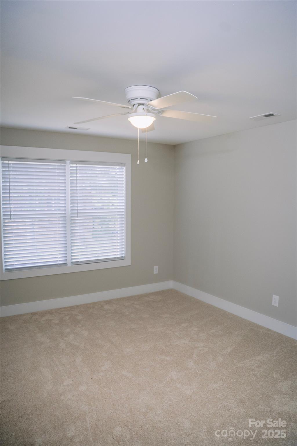 1004 East Sandy Ridge Road Monroe, NC 28112 - Photo 24 of 25 an empty room with windows and fan