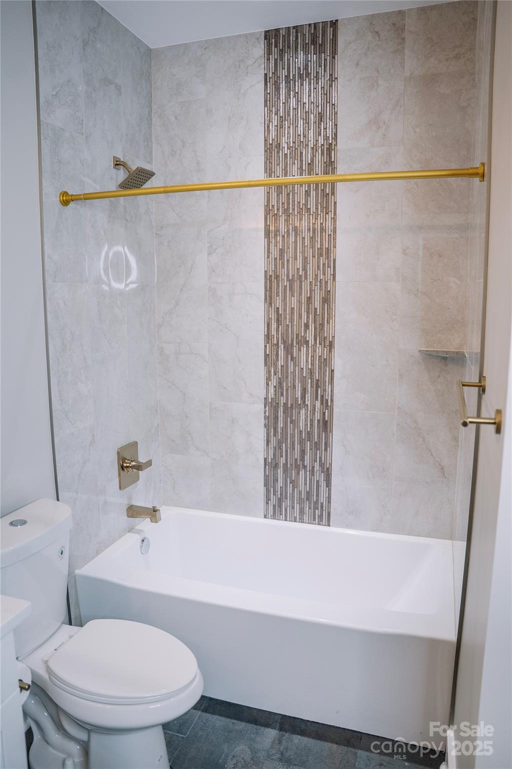 1004 East Sandy Ridge Road Monroe, NC 28112 - Photo 6 of 25 a white bath tub sitting next to a white toilet and sink