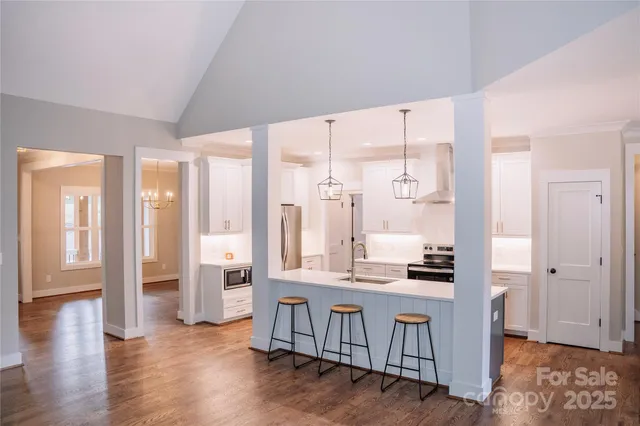 a large white kitchen with a large window