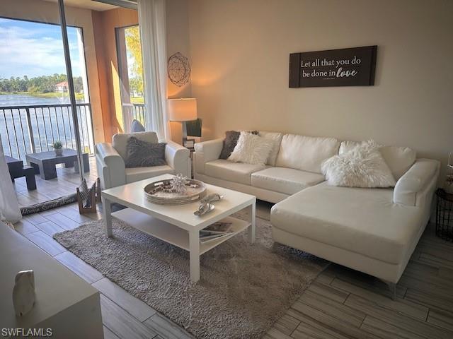 1205 Reserve Way, Unit 308 Naples, FL 34105 - Photo 1 of 21 a living room with furniture and a table