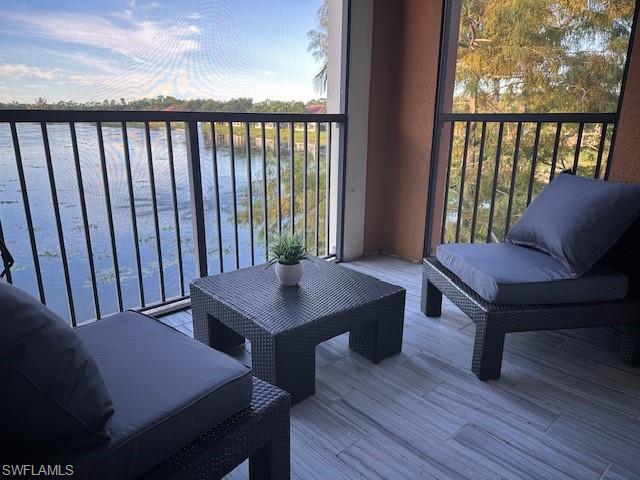 1205 Reserve Way, Unit 308 Naples, FL 34105 - Photo 14 of 21 a view of a balcony with furniture and wooden floor