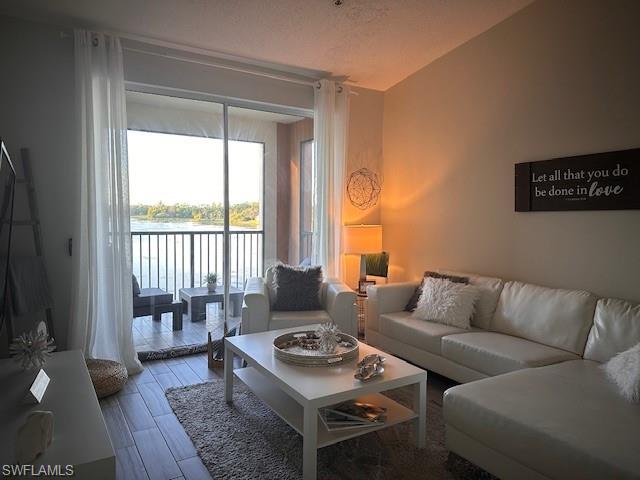 1205 Reserve Way, Unit 308 Naples, FL 34105 - Photo 2 of 21 a living room with furniture and a window