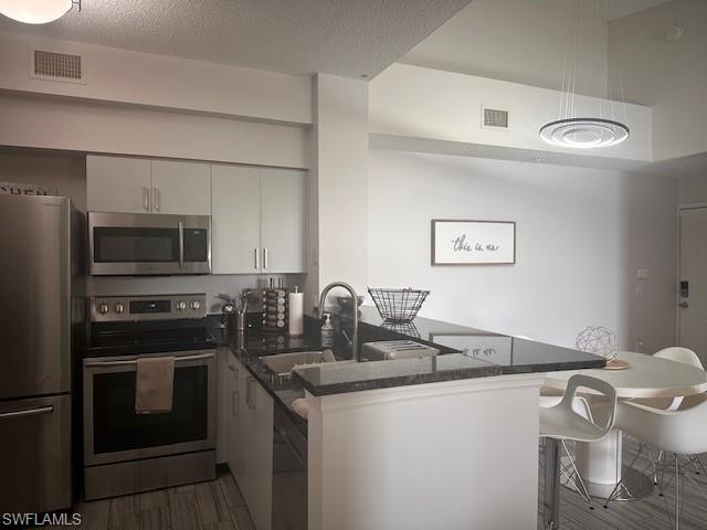 1205 Reserve Way, Unit 308 Naples, FL 34105 - Photo 5 of 21 a kitchen with a sink a stove and refrigerator