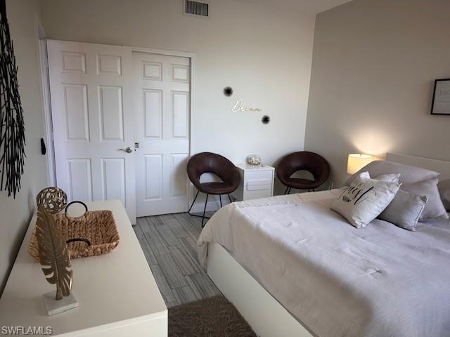 1205 Reserve Way, Unit 308 Naples, FL 34105 - Photo 7 of 21 a bedroom with bed and mirror