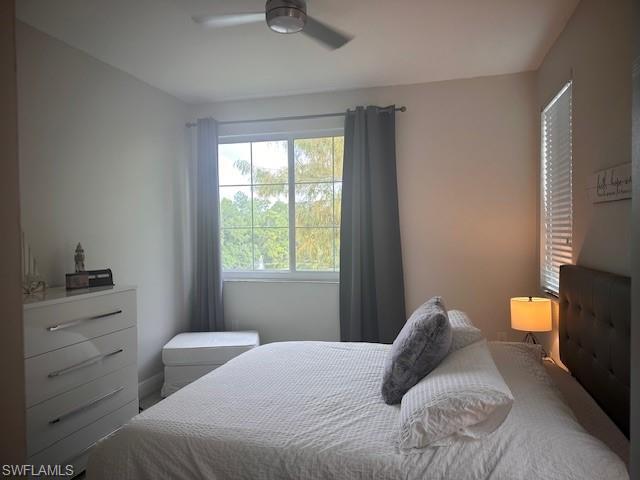 1205 Reserve Way, Unit 308 Naples, FL 34105 - Photo 8 of 21 a bedroom with a bed and window