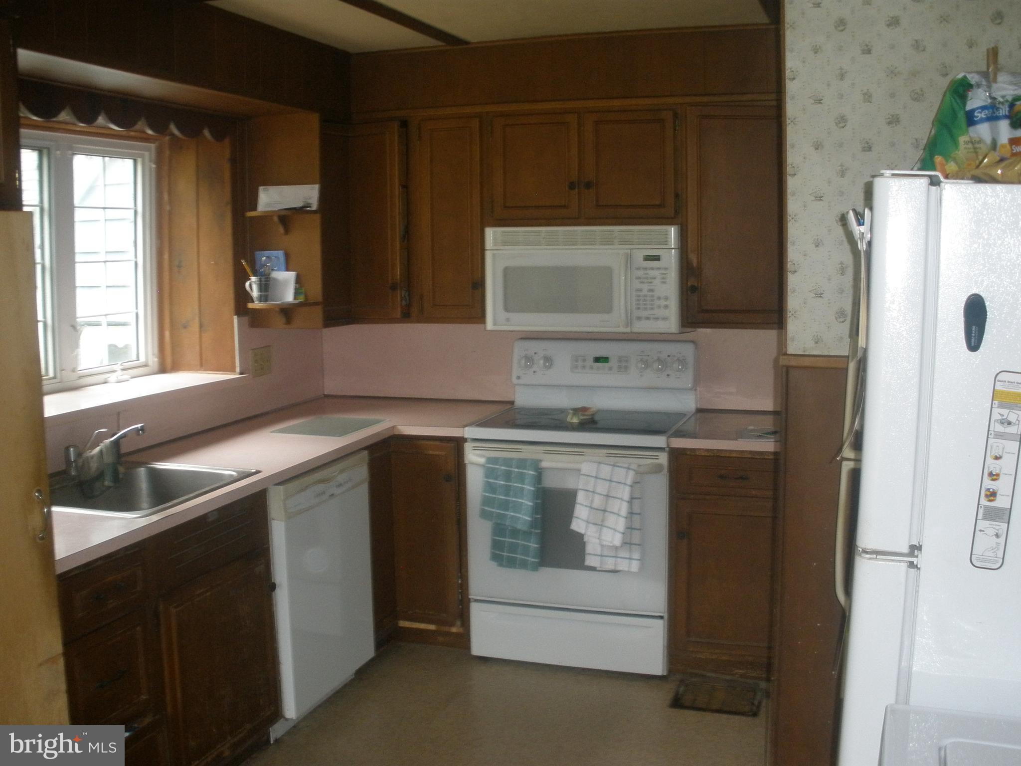 14103 Rockdale Road Clear Spring, MD 21722 - Photo 9 of 24 a kitchen with a stove microwave and sink