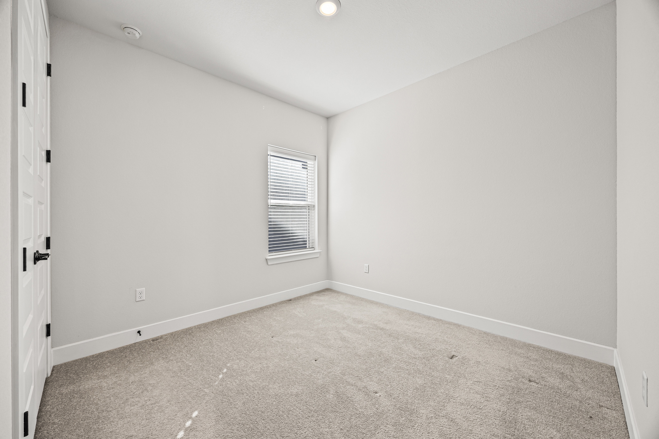5806 Rangeland Road Austin, TX 78747 - Photo 24 of 34 A well-lit bedroom with fresh carpeting awaits your personal touch.