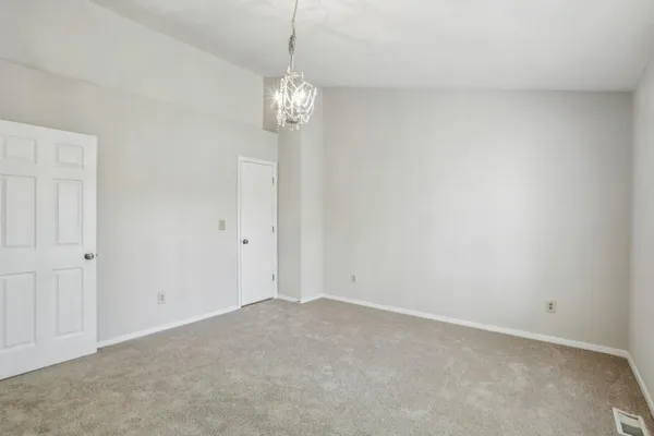 a view of empty room with chandelier