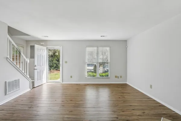 wooden floor in an empty room with a window