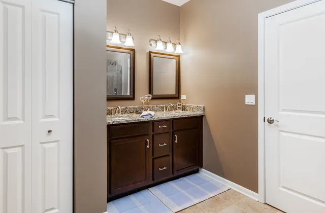 a bathroom with a double vanity sink and a mirror