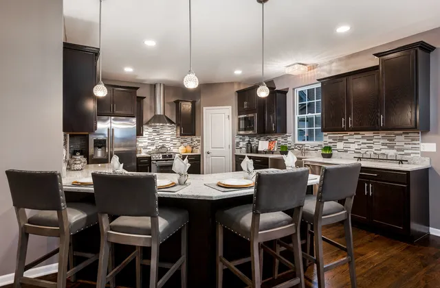 a dining room with a table chairs and a kitchen view
