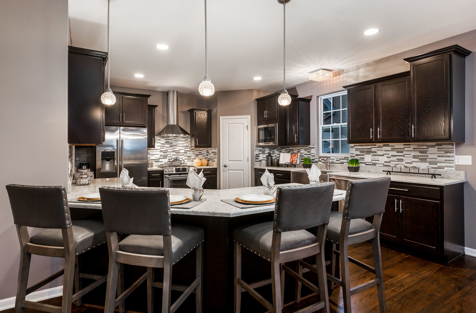 2831 Rood Street Yorkville, IL 60560 - Photo 3 of 17 a dining room with a table chairs and a kitchen view