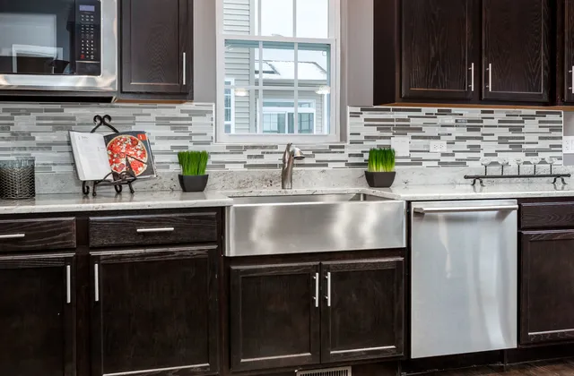 a kitchen with stainless steel appliances granite countertop a sink stove and cabinets