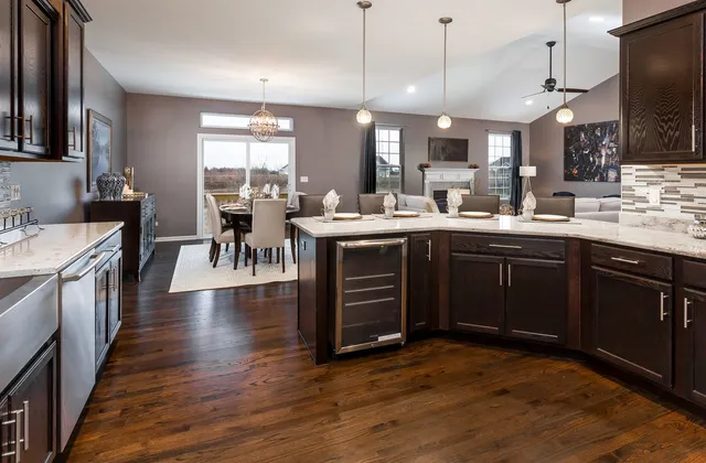 a kitchen with lots of counter space a sink appliances and dining table