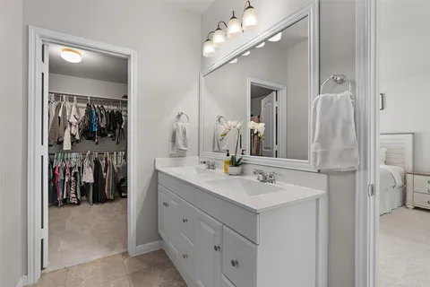 a bathroom with a sink vanity and a mirror