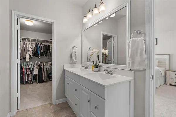 a bathroom with a sink vanity and a mirror