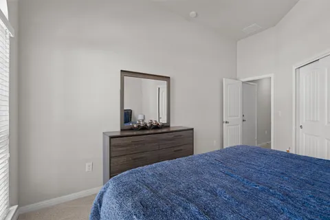 a bedroom with a bed and a dresser