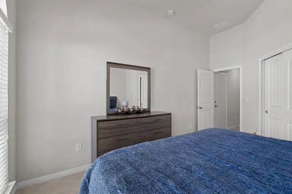 a bedroom with a bed and a dresser