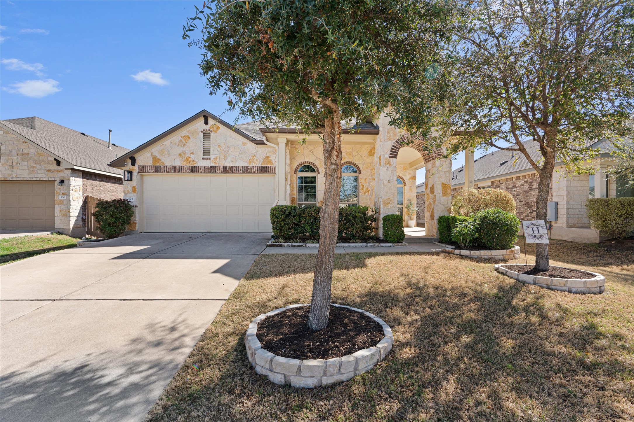 524 Longhorn Cavern Road Leander, TX 78641 - Photo 2 of 34 View of front of house with driveway, an attached garage, stone siding