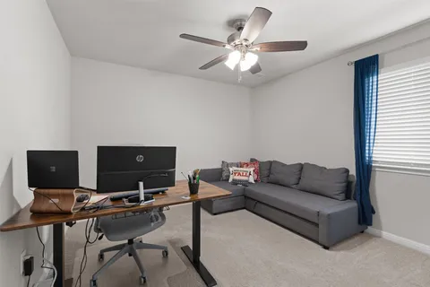 a living room with furniture and a laptop