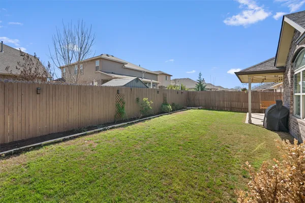 a view of a backyard with a tree