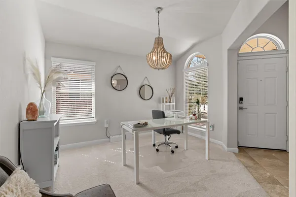 a view of a livingroom with furniture window and a chair