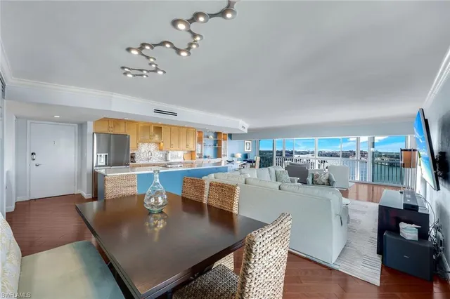a living room with lots of furniture and view of kitchen