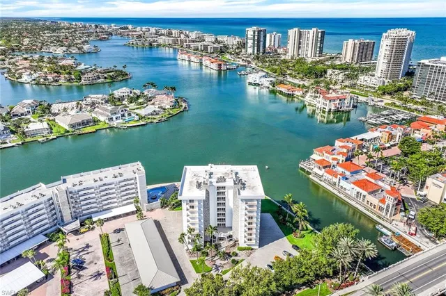 an aerial view of a house with outdoor space swimming pool and ocean view