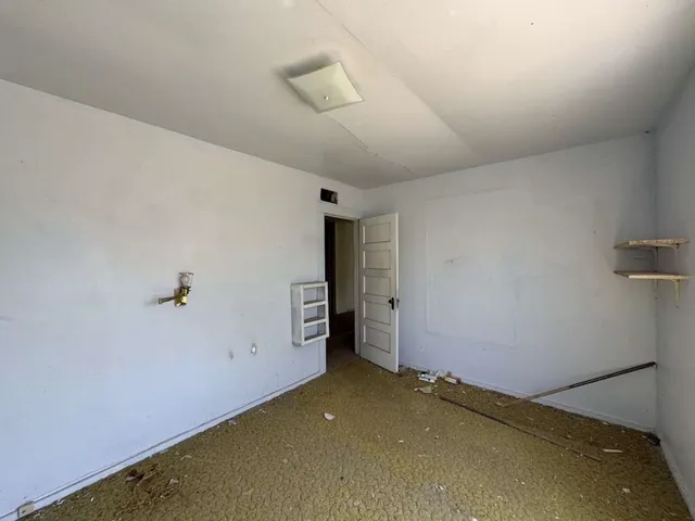 a view of a hallway with wooden cabinets