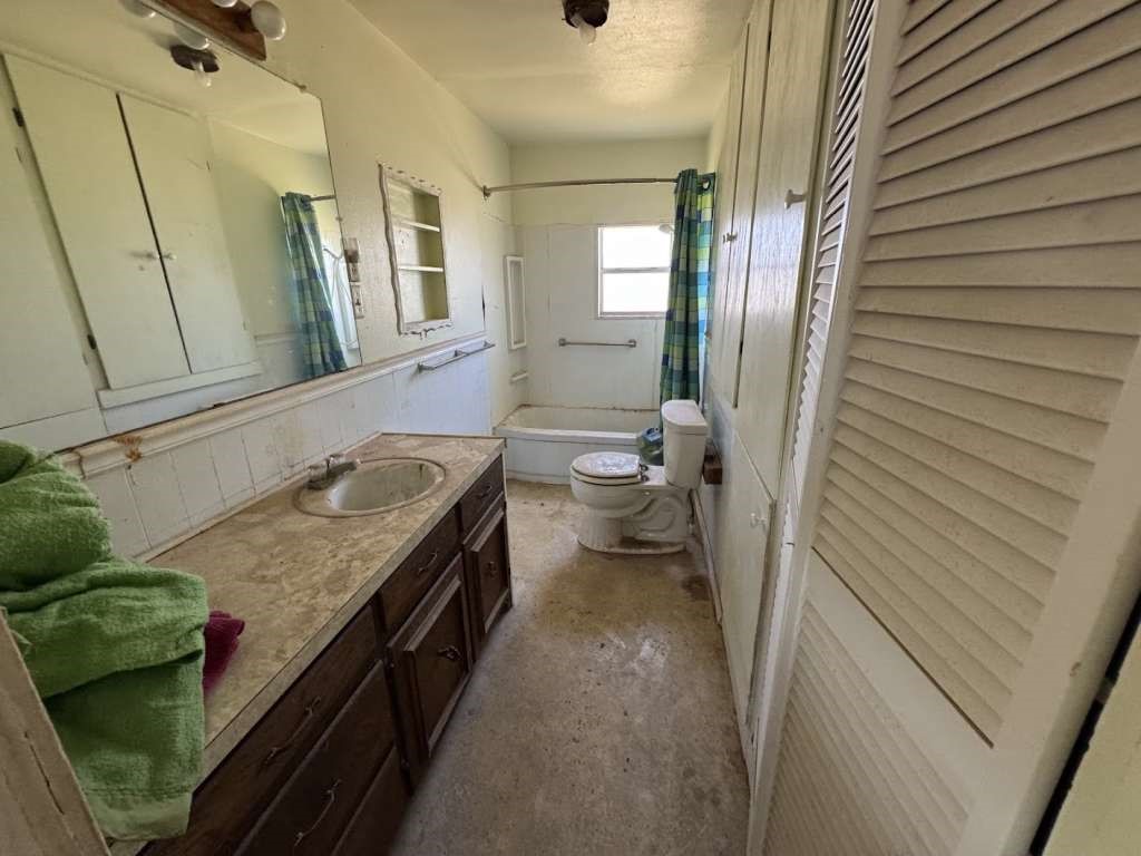 4608 Wasson Road Big Spring, TX 79720 - Photo 7 of 13 a bathroom with a granite countertop sink and a mirror
