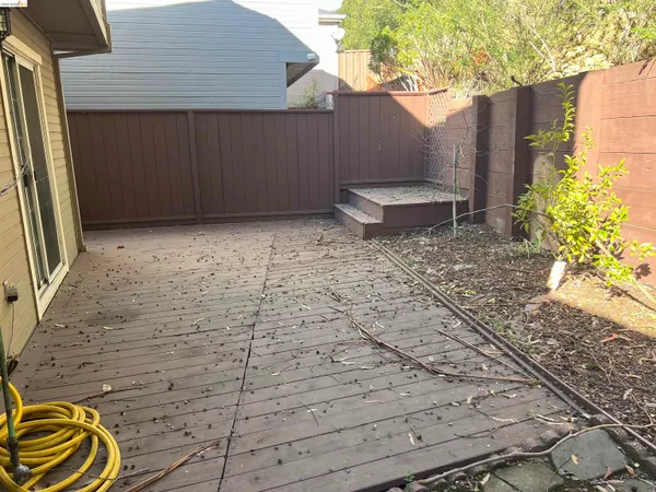 a backyard of a house with table and chairs