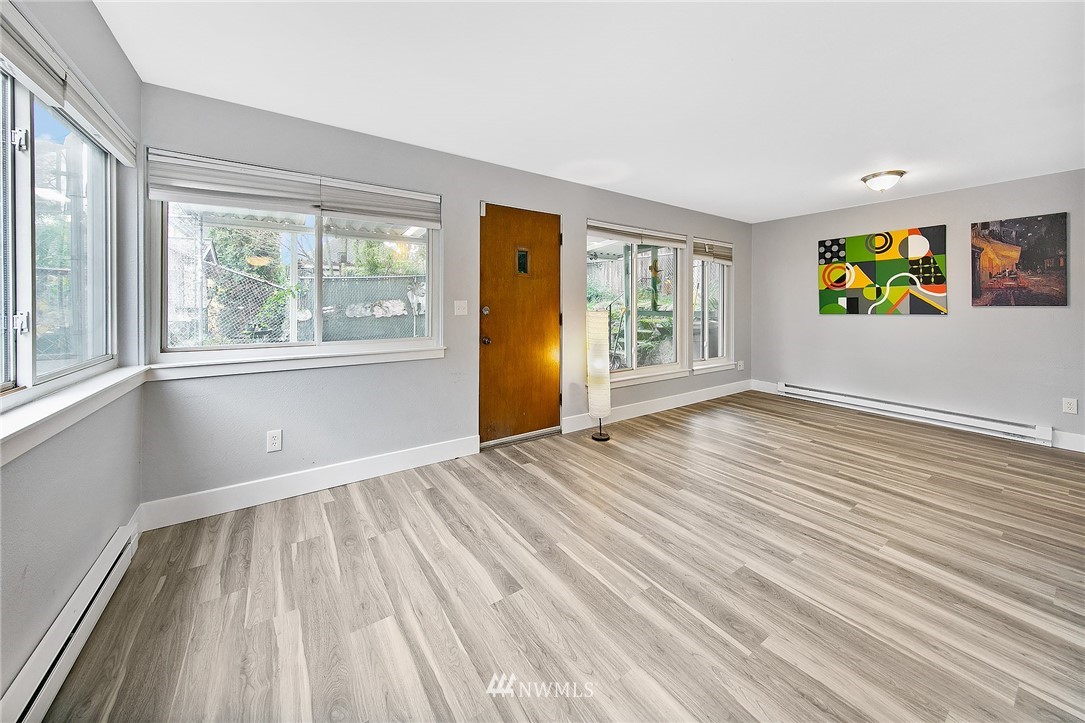 931 North 85th Street, Unit 5 Seattle, WA 98103 - Photo 6 of 11 an empty room with window and wooden floor