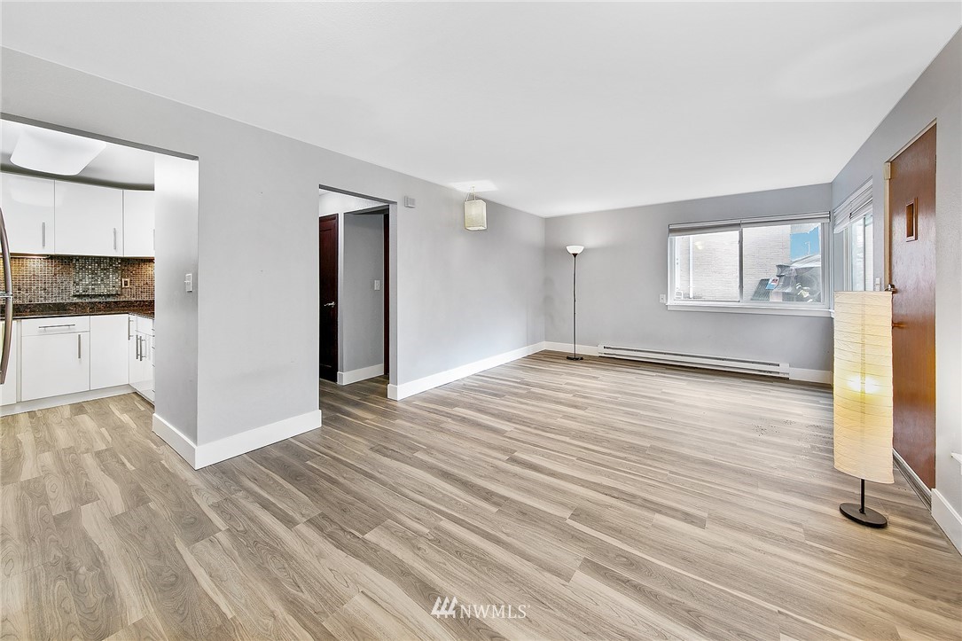 931 North 85th Street, Unit 5 Seattle, WA 98103 - Photo 7 of 11 wooden floor in an empty room with a window