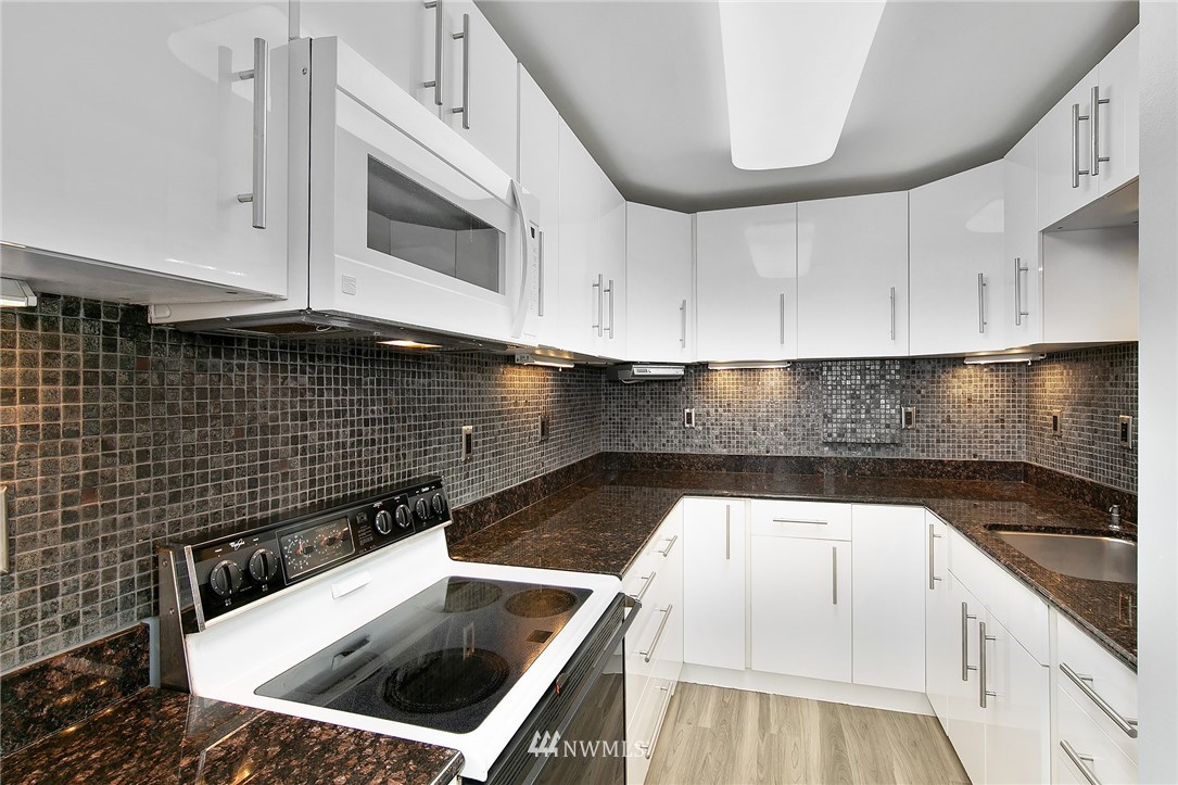 931 North 85th Street, Unit 5 Seattle, WA 98103 - Photo 8 of 11 a kitchen with a sink and cabinets