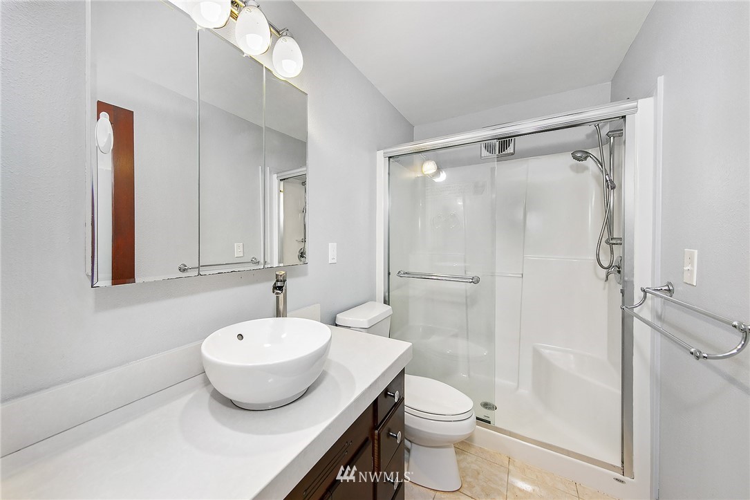 931 North 85th Street, Unit 5 Seattle, WA 98103 - Photo 10 of 11 a bathroom with a sink toilet and shower