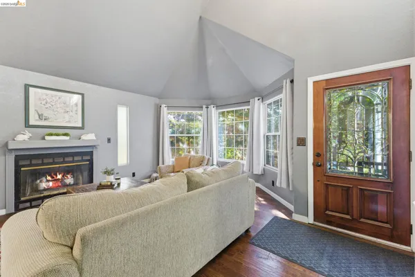 a bed sitting in a spacious bedroom next to a window