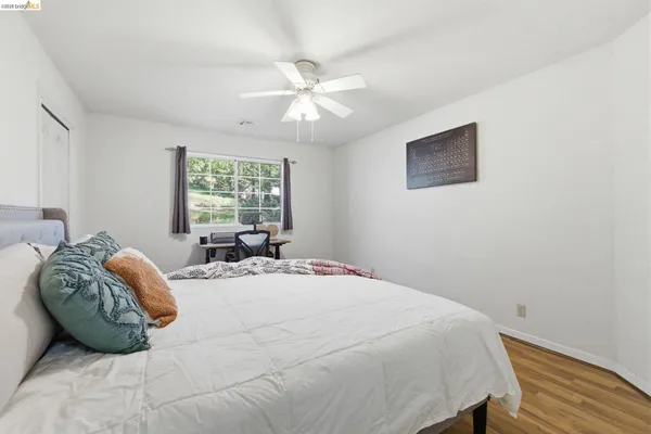 an aerial view of a house with a yard and large trees