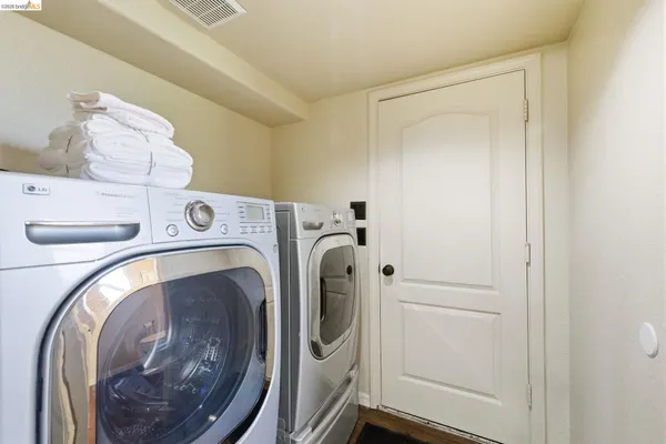 a view of a lush green field with mountains in the background