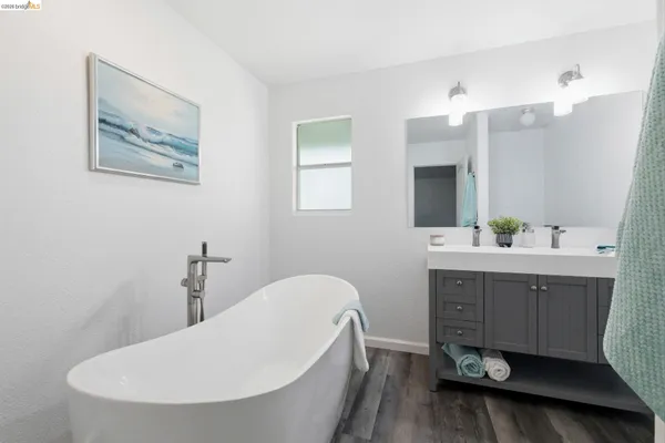 a bathroom with a double vanity sink mirror and toilet