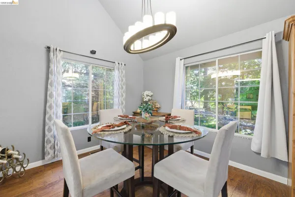 a view of a dining room with furniture window and wooden floor