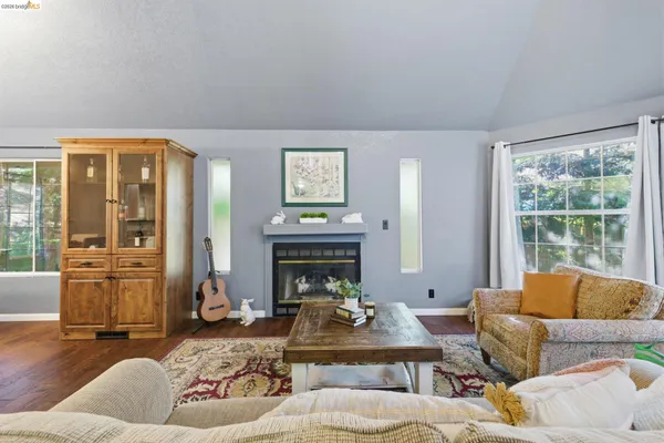 a living room with fireplace furniture and a flat screen tv