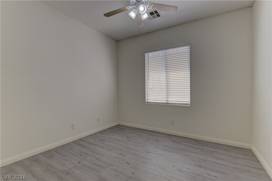 4613 Rising Cove Street Las Vegas, NV 89129 - Photo 12 of 20 This bright room features a ceiling fan and elegant flooring, offering a comfortable atmosphere.
