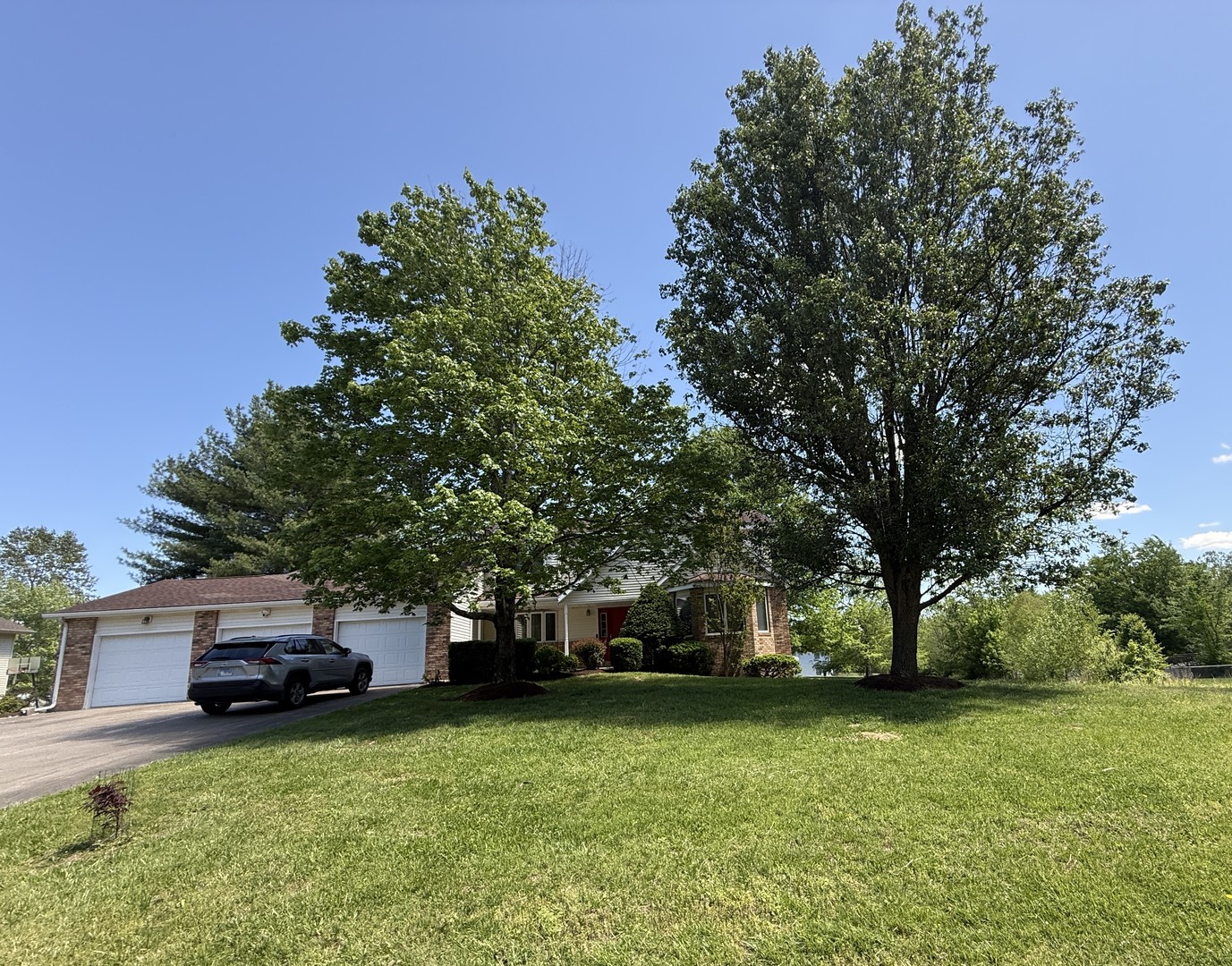 a front view of a house with a garden