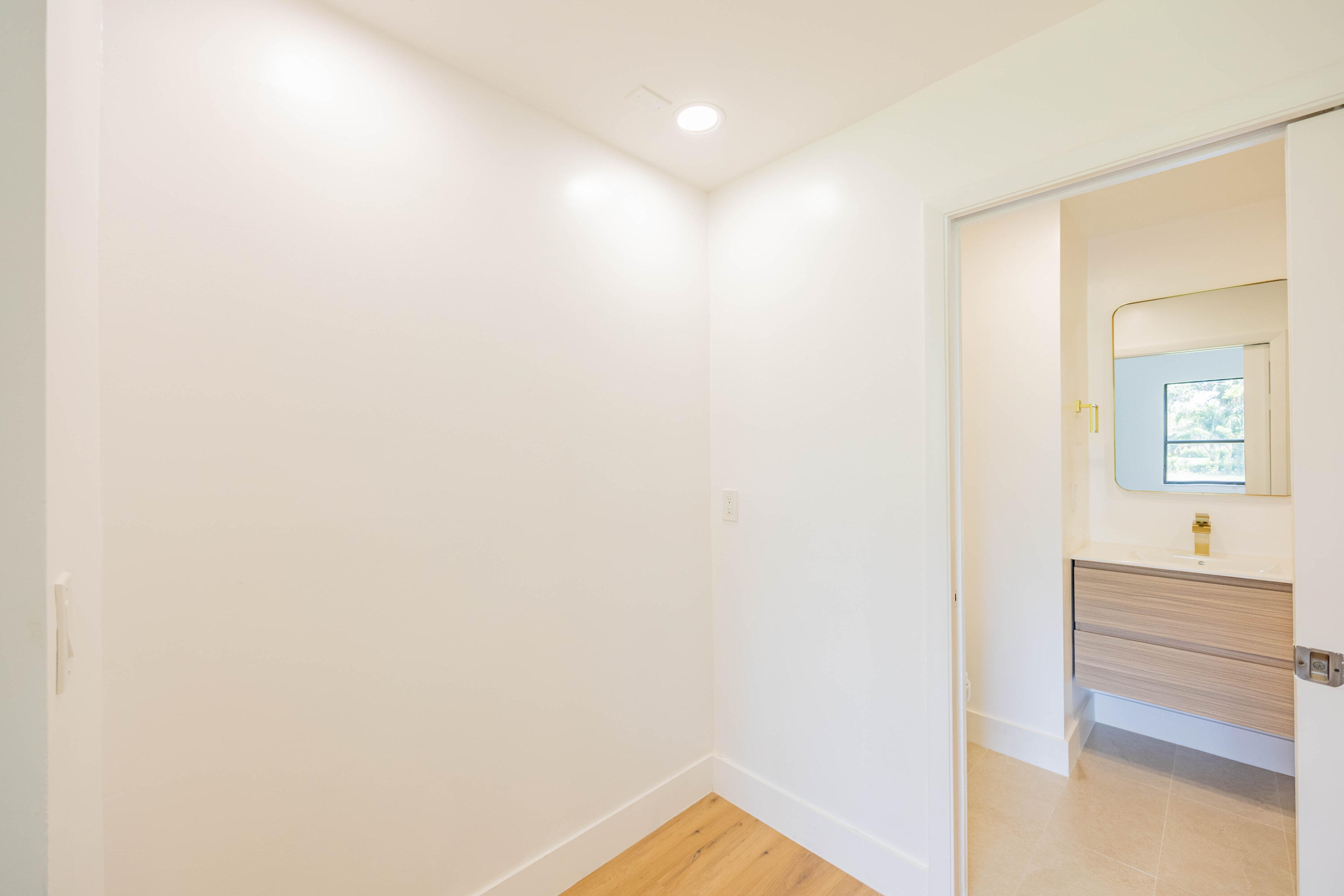 7520 La Paz Boulevard, Unit 104 Boca Raton, FL 33433 - Photo 26 of 56 a view of a bedroom from a hallway
