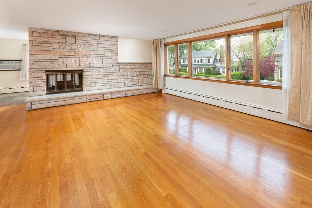 39 Cedarwood Road Boston, MA 02130 - Photo 2 of 11 an empty room with fireplace and windows