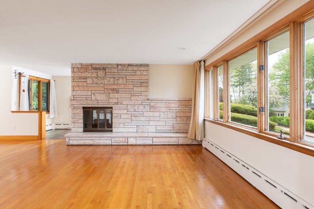 39 Cedarwood Road Boston, MA 02130 - Photo 3 of 11 a view of empty room with wooden floor and fireplace