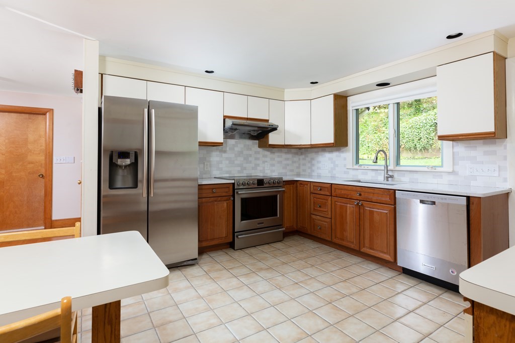 39 Cedarwood Road Boston, MA 02130 - Photo 6 of 11 a kitchen with stainless steel appliances granite countertop a stove a sink and a refrigerator